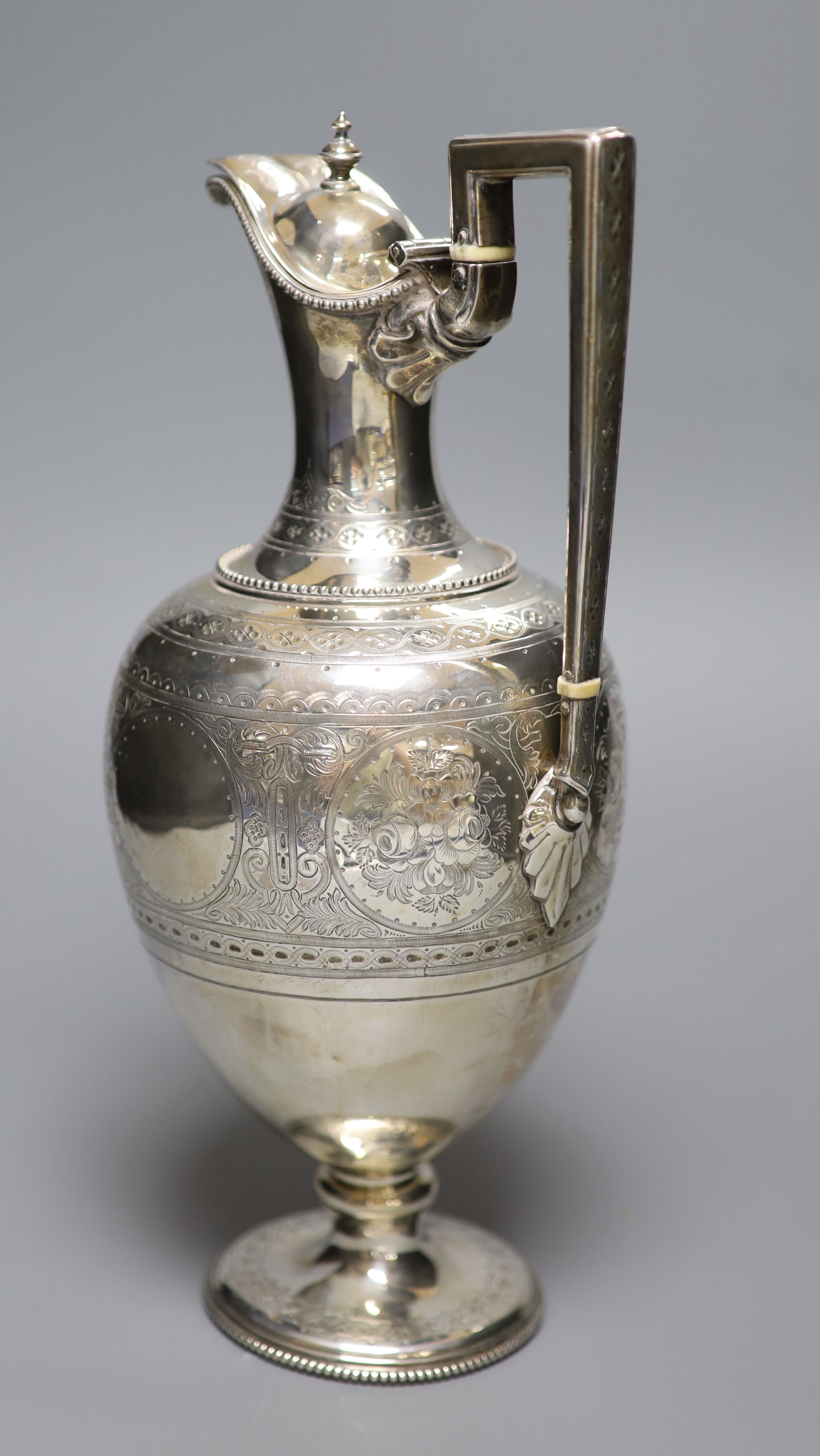 A Victorian engraved silver baluster hot water jug, Martin, Hall & Co, London, 1874